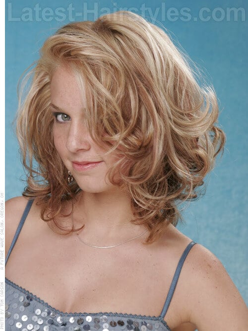Medium Blonde Hairstyle with Curls and Highlights Side View