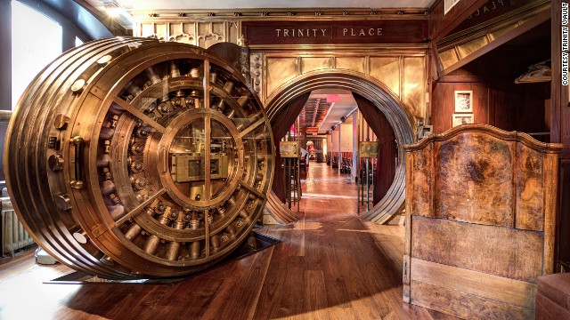 A set of two century-old 35-ton doors lead to the former underground vaults of the United States Realty Bank in New York. The first room of Trinity Place is a buzzy lounge area, while the second is a dining room.