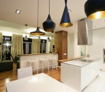 Each dining space in the home is marked out with a run of attractive pendant lights.
