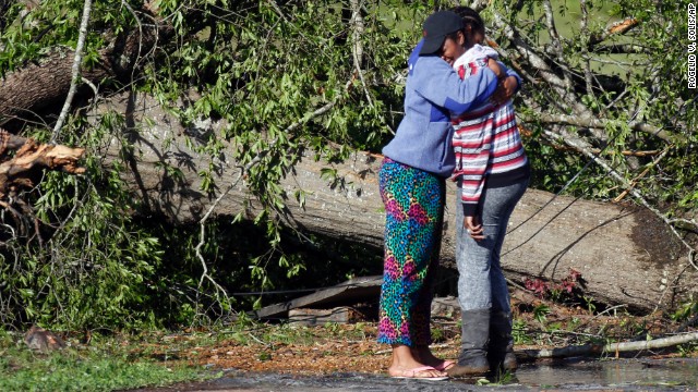 Carnesha Bennett, right, cries on a friend's shoulder after touring what remains of her mother's child-care center in Louisville, Mississippi, on Tuesday, April 29. A powerful storm system, including some tornadoes, has claimed more than two dozen lives in six states this week.