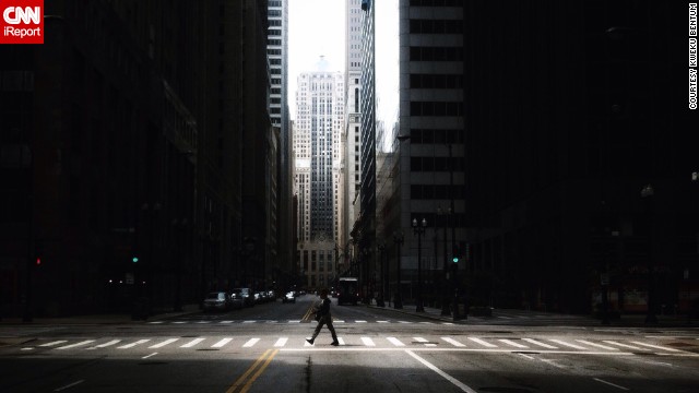A <a href='http://ift.tt/1m9Wb8i'>lone walker</a> crosses an urban canyon on LaSalle Street.