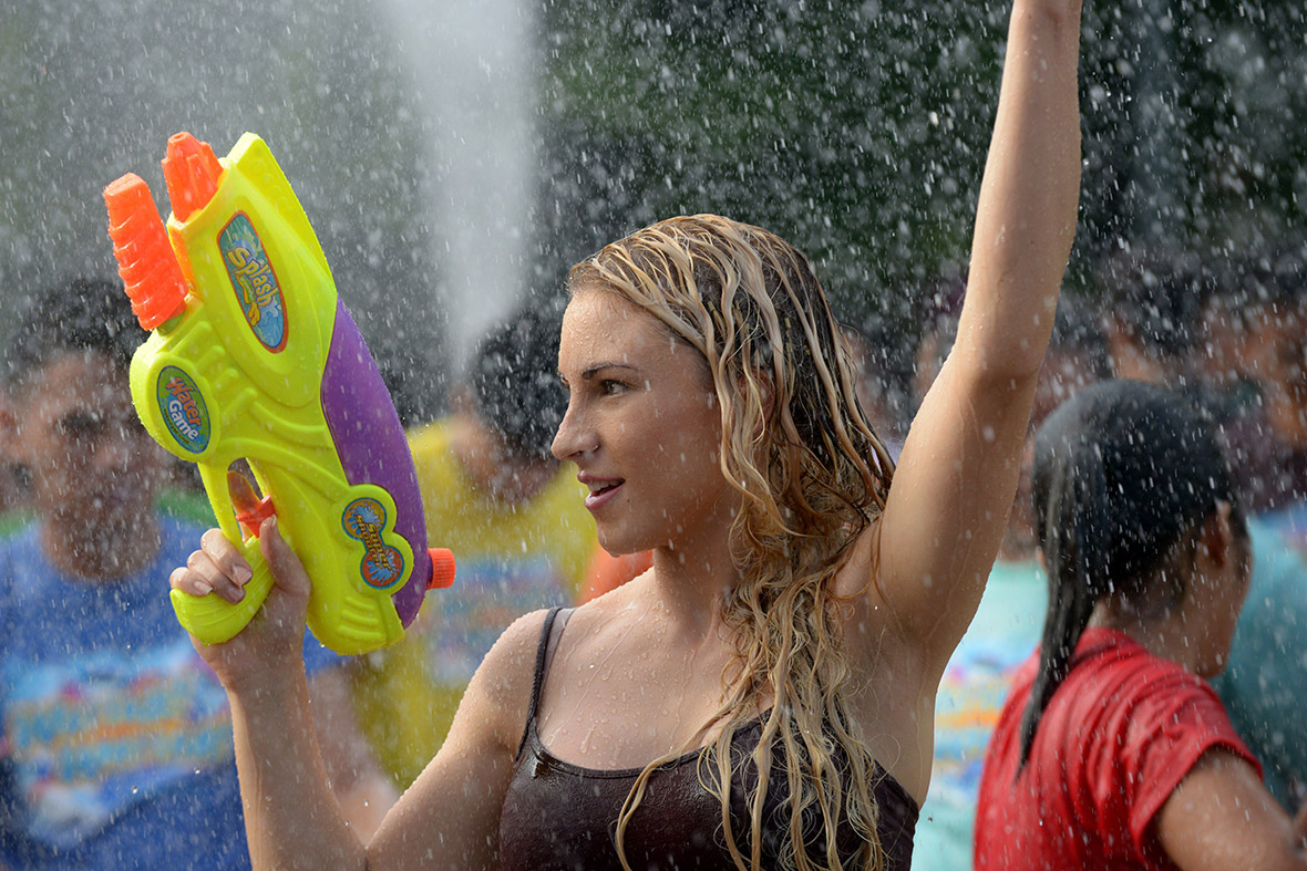 People spray each other with water-pistols to celebrate the feast day of St John the Baptist in Manila, Philippines