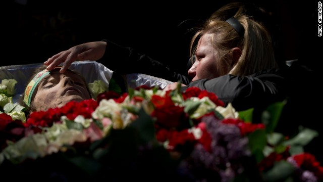 A relative mourns by the body of 17-year-old Vadim Papura during a service in Odessa on May 6. Papura died after jumping out of a burning trade union building during riots on May 2.