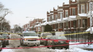 Police investigate a murder of a 68-year-old man in the Logan Square neighborhood of Chicago on December 15, 2013.
