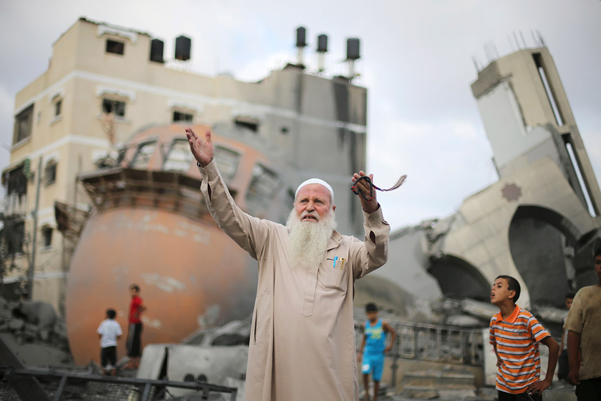 A Palestinian man reacts in front of the remains of a mosque, which witnesses said was destroyed in an Israeli air strike before a 72-hour truce, in Khan Younis in the southern Gaza Strip