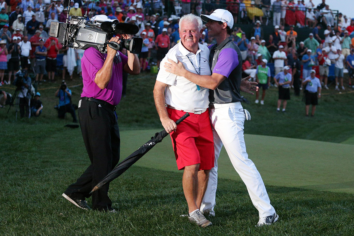 Rory McIlroy hugs his father Gerry after winning the 2014 PGA Championship golf tournament at Valhalla Golf Club in Louisville, Kentucky