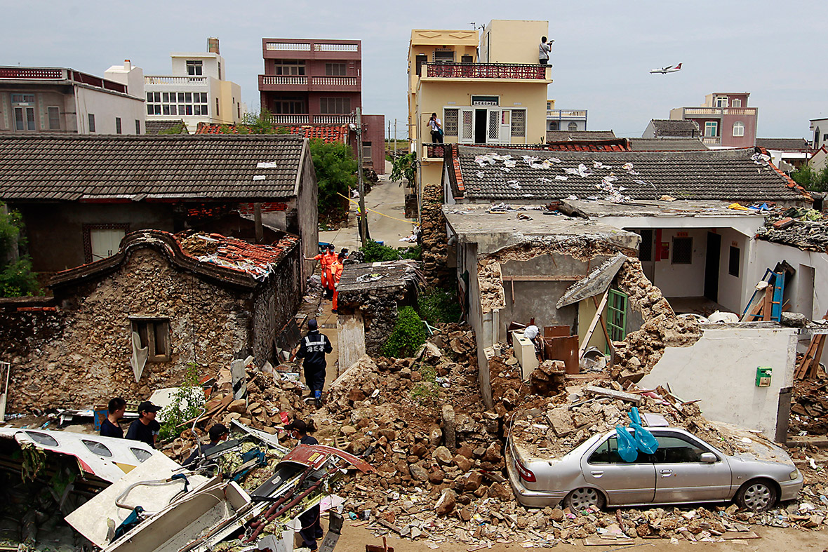Plane wreckage and demolished houses are seen in the village of Xixi