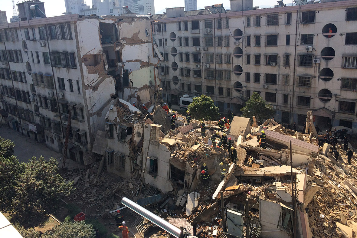 Firefighters search for survivors after an apartment building collapsed in Fenghua, Zhejiang Province, China