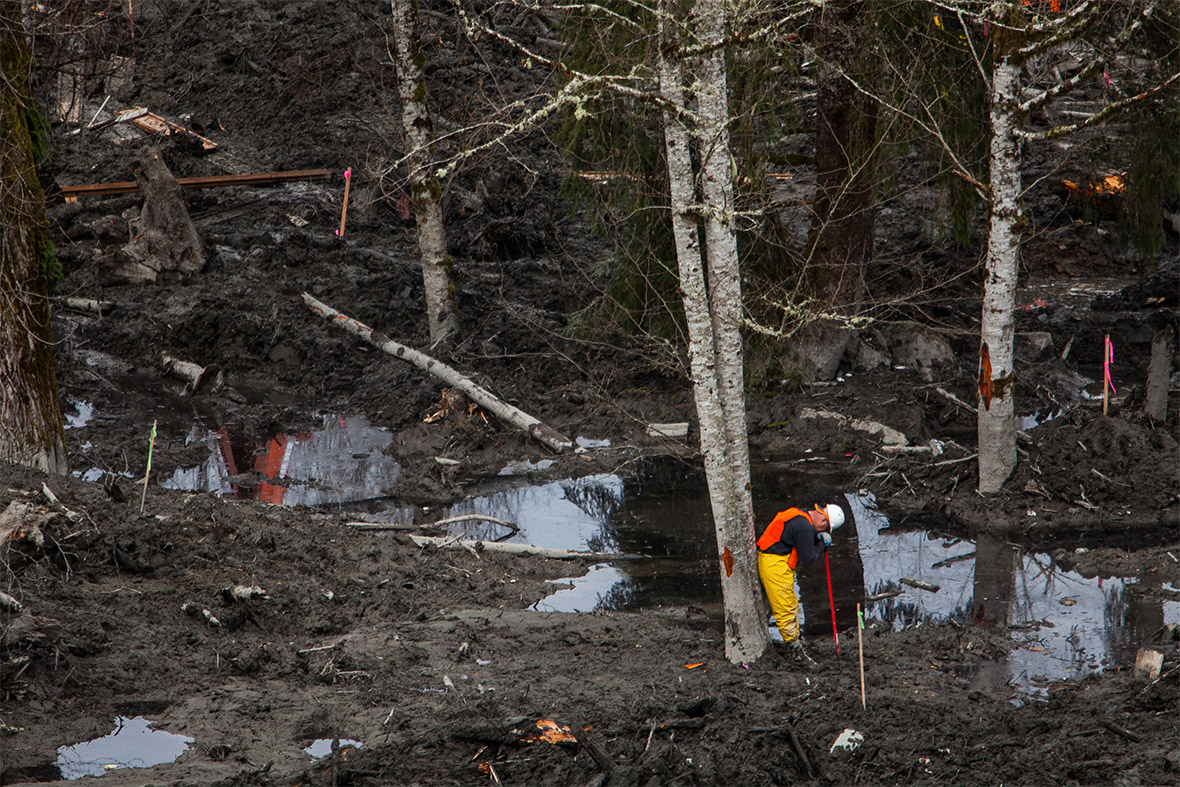 A rescue worker takes a break while searching through debris left by a mudslide in Oso, Washington