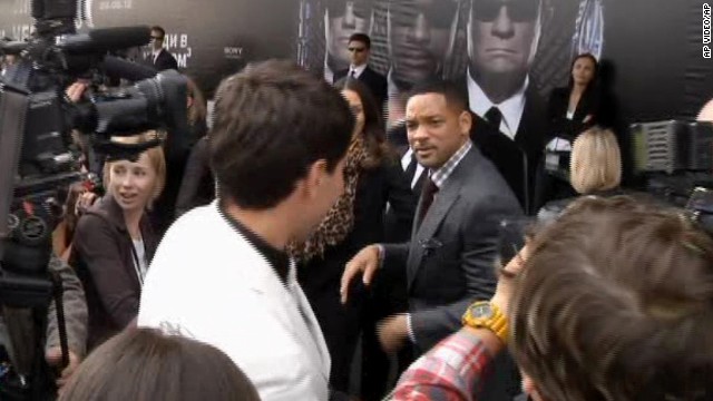 Will Smith walks away after slapping Sediuk, white jacket, who had just tried to kiss him, on the red carpet of the premiere of "Men in Black III" in Moscow in 2012.