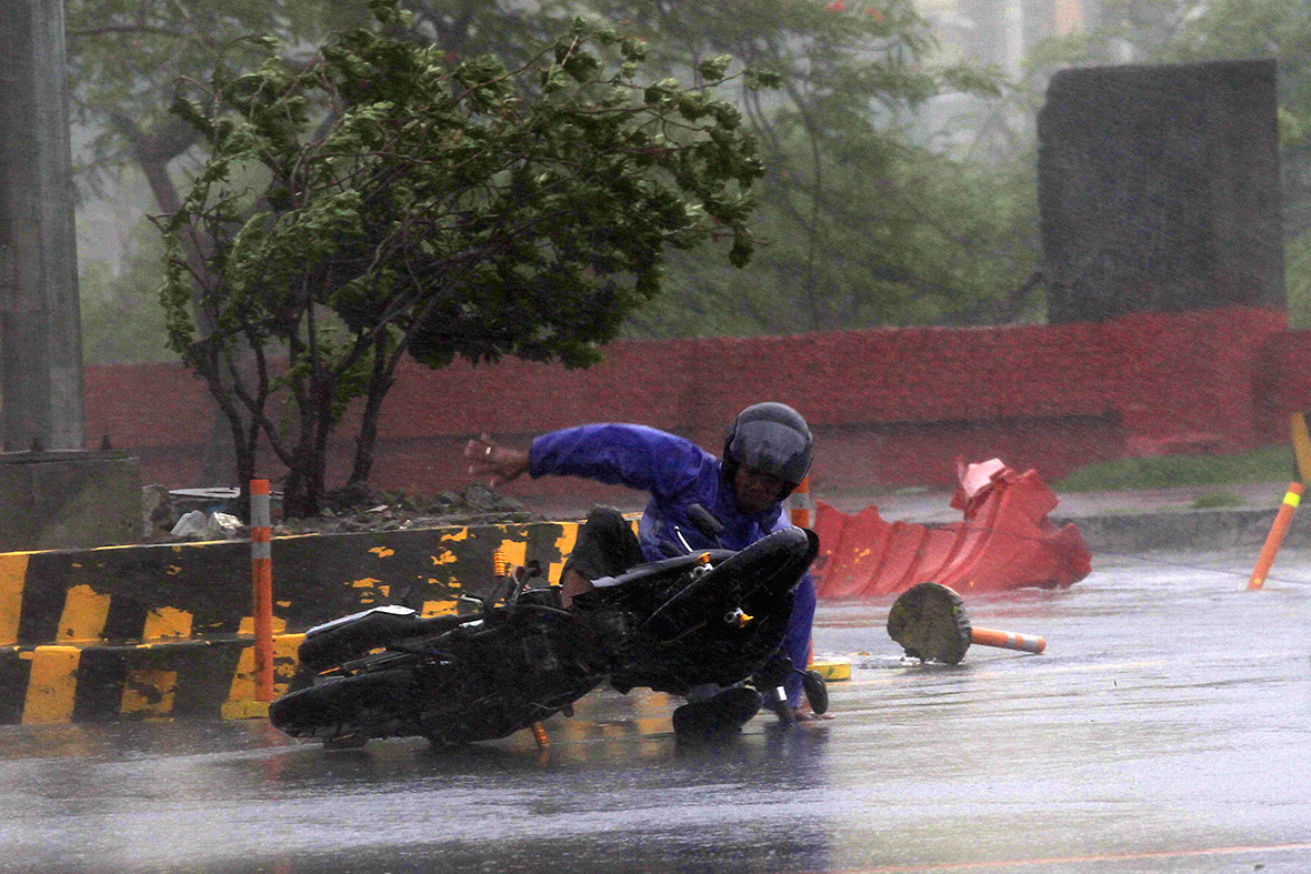 A motorcyclist is blown over by fierce winds in Manila.