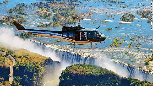 With fully open side doors, the 13-passenger Huey zigzags above the Zambezi River before rapidly rising up and over Victoria Falls.