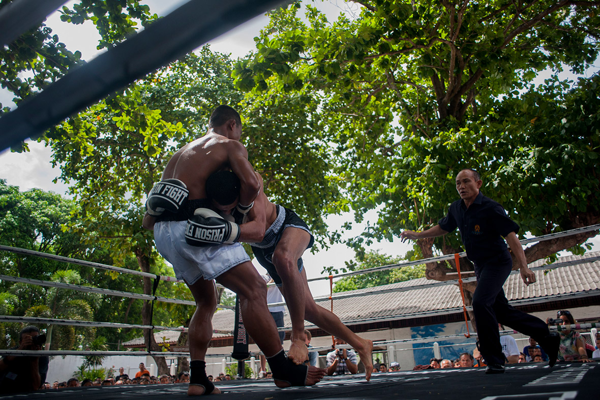 A foreign fighter and an inmate compete during a Muay Thai fight at Klong Pai prison