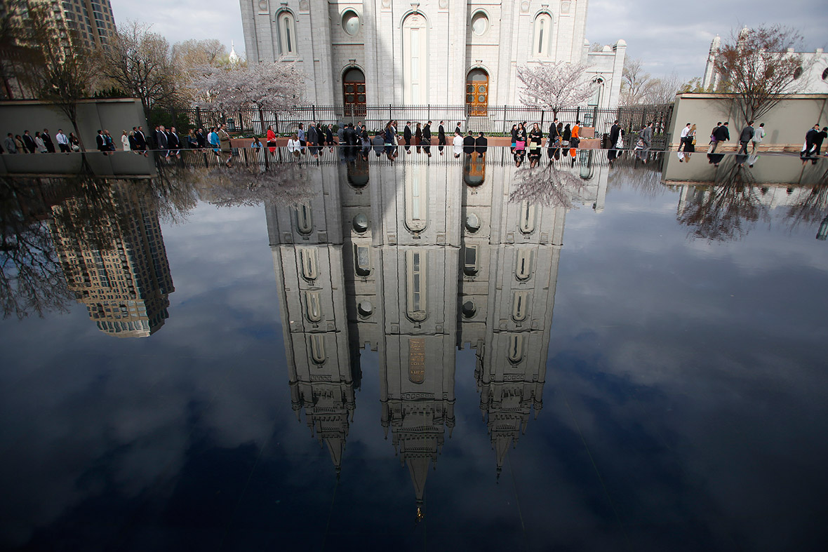 People walk past Salt Lake temple as they arrive to attend the biannual general conference of the Church of Jesus Christ of Latter-day Saints – more commonly known as Mormons – in Salt Lake City, Utah