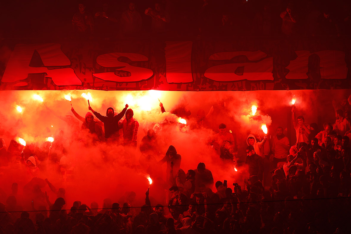 Galatasaray fans light flares to celebrate a goal against Fenerbahce during the Turkish Super League derby match in Istanbul