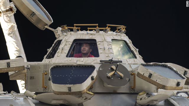 Commander Koichi Wakata of the Japan Aerospace Exploration Agency peers out of the space station's Cupola observatory on April 27. The Cupola is a dome-shaped module that allows station crew members to observe and guide activities outside the station.
