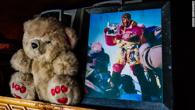 A photograph of Ang Tshiring's son, Pemba Sherpa, atop Mount Everest holding a picture of his family. "I've summited Everest 14 times and I always brought a photograph of my family with me," he says. 