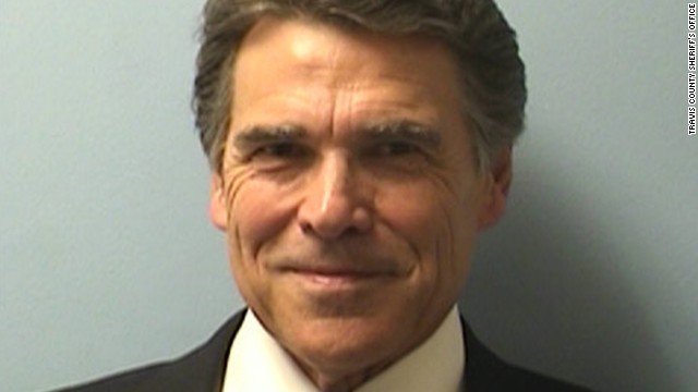 Perry was booked on Tuesday on two felony charges related to his handling of a local political controversy. He vowed to fight the charges.