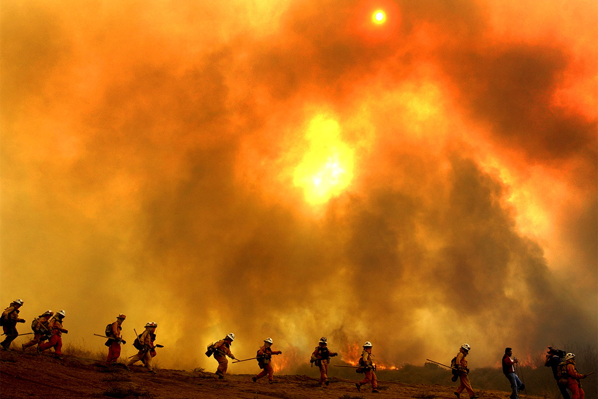 Firefighters scurry down a blazing hillside to escape a sudden flare-up while tackling a huge wildfire in California. Fires are expected to become more regular and more severe as temperatures rise, drying out the vegetation
