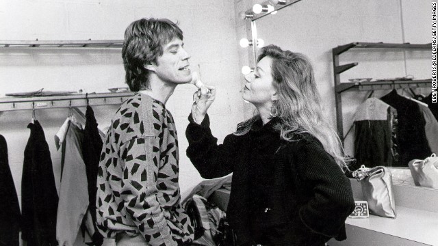Makeup is applied to Mick Jagger's face backstage in 1984.