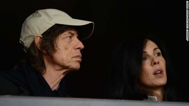 Mick Jagger watches the 2012 Olympic Games in London with his girlfriend, American fashion designer L'Wren Scott. Scott died in early 2014.