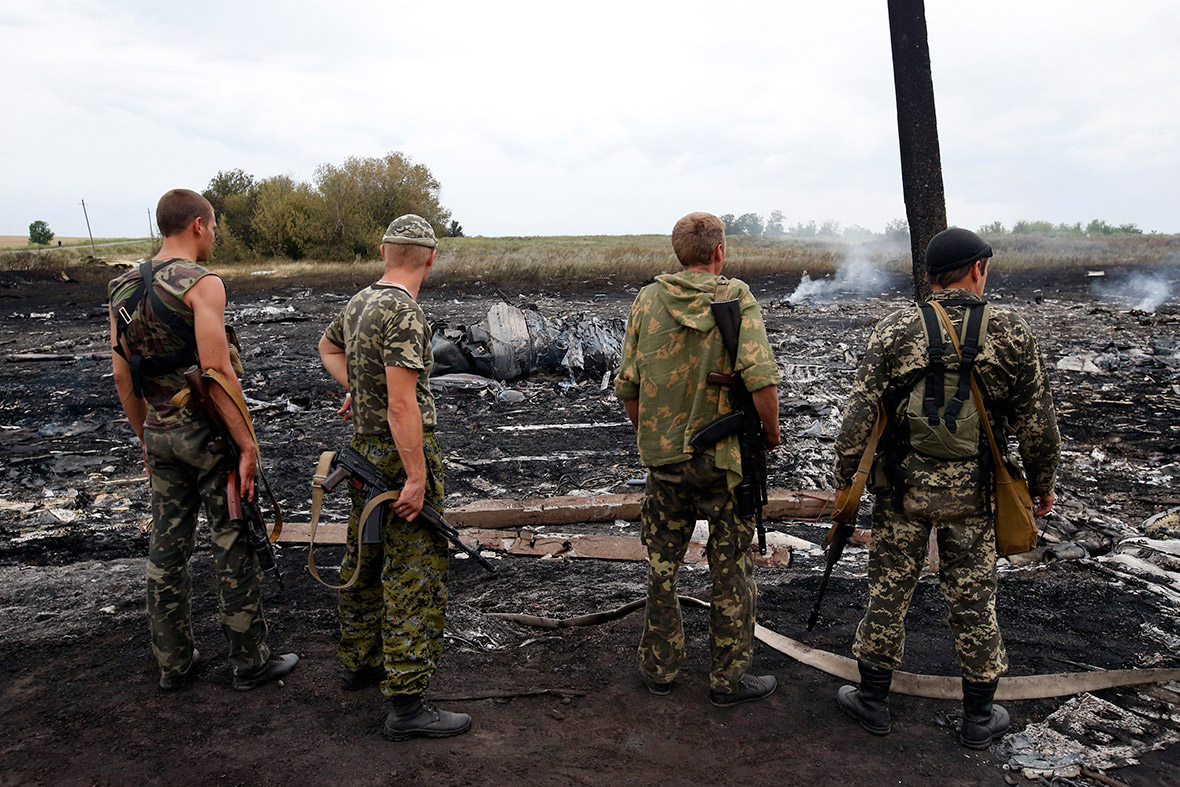 Armed pro-Russian separatists stand at the site of the Malaysia Airlines Boeing 777 plane crash.