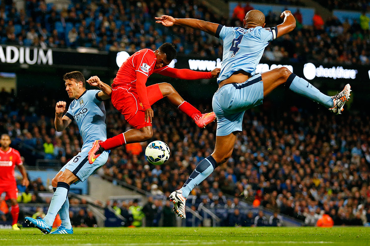 Liverpool's Daniel Sturridge is challenged by Manchester City's Martin Demechelis and Vincent Kompany during their Premier League match at the Etihad stadium in Manchester