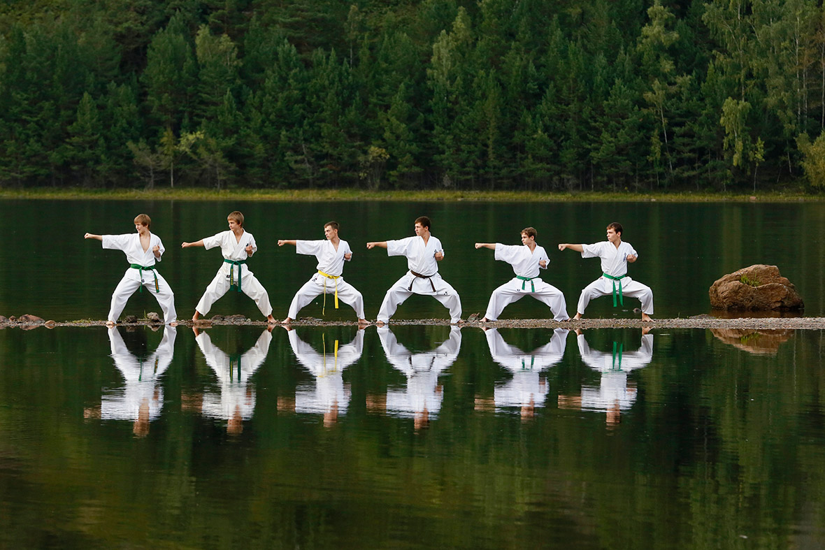 Young members of a local karate federation perform during an exercise session at a summer training camp on a bank of the Yenisei River near the town of Divnogorsk, Siberia