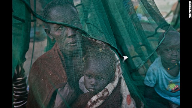 One of the few to have a mosquito net, a displaced family who fled the recent fighting between government and rebel forces in Bor by boat across the White Nile, sit under it in Awerial, South Sudan, on Thursday, January. 2.