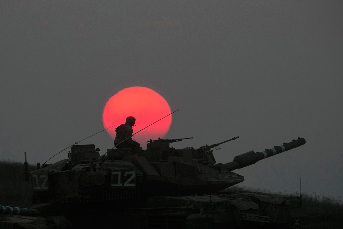 An Israeli tank manoeuvres outside the northern Gaza Stripat sunset