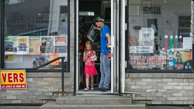 Residents leave a convenience store in a part of Lac Megantic that reopened on July 9.