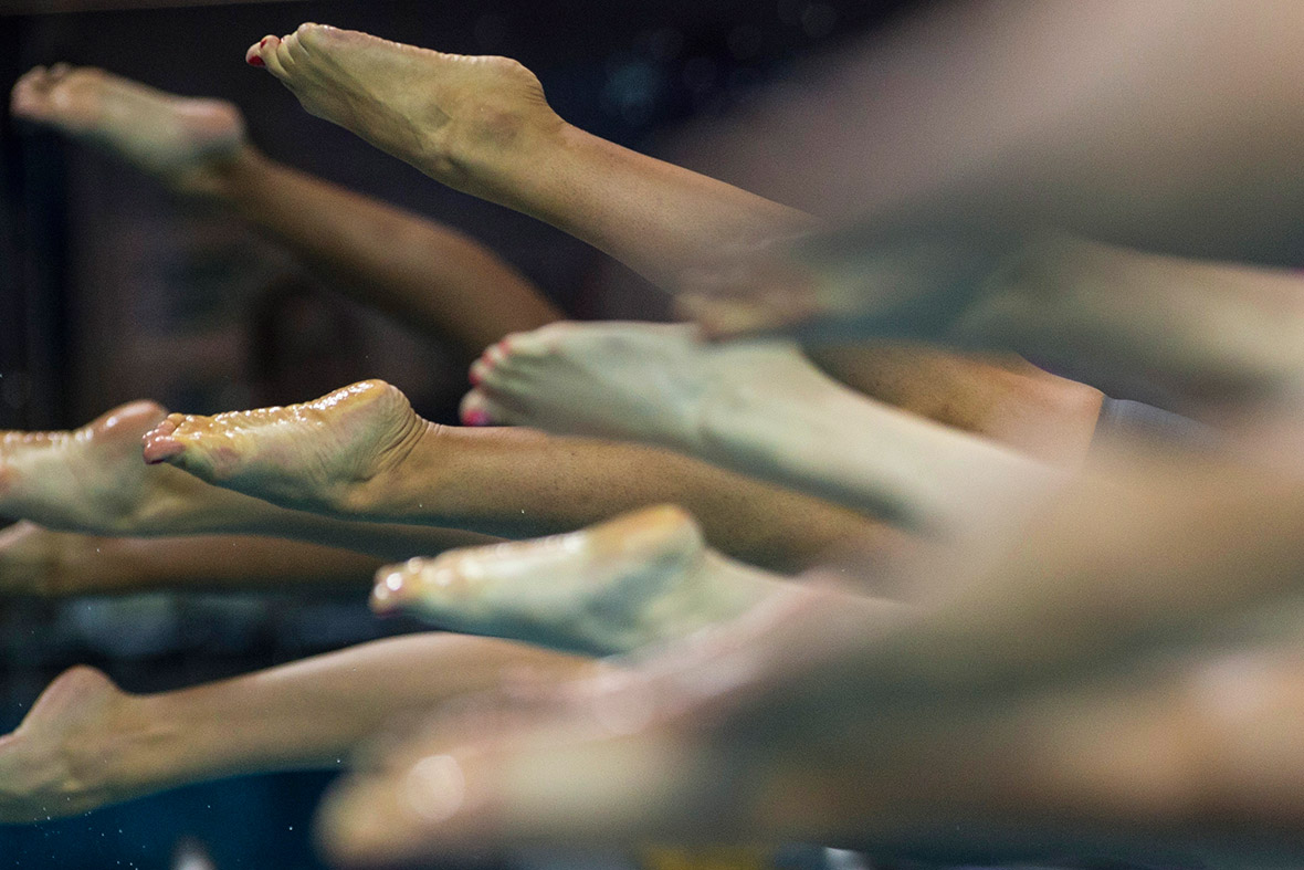 Competitors dive into the pool at the start of a women's 200m freestyle heat at the 2014 Nanjing Youth Olympic Games