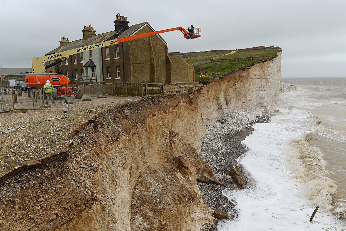 Work begins to demolish the end terrace cottage at Birling Gap near Eastbourne, as it was in danger of collapsing after cliff erosion