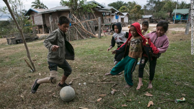 One of the land mine victims photographer Paula Bronstein met in Laos was a 10-year-old named Aiyaok. He is seen here playing soccer with other children in the village of Tamluang.