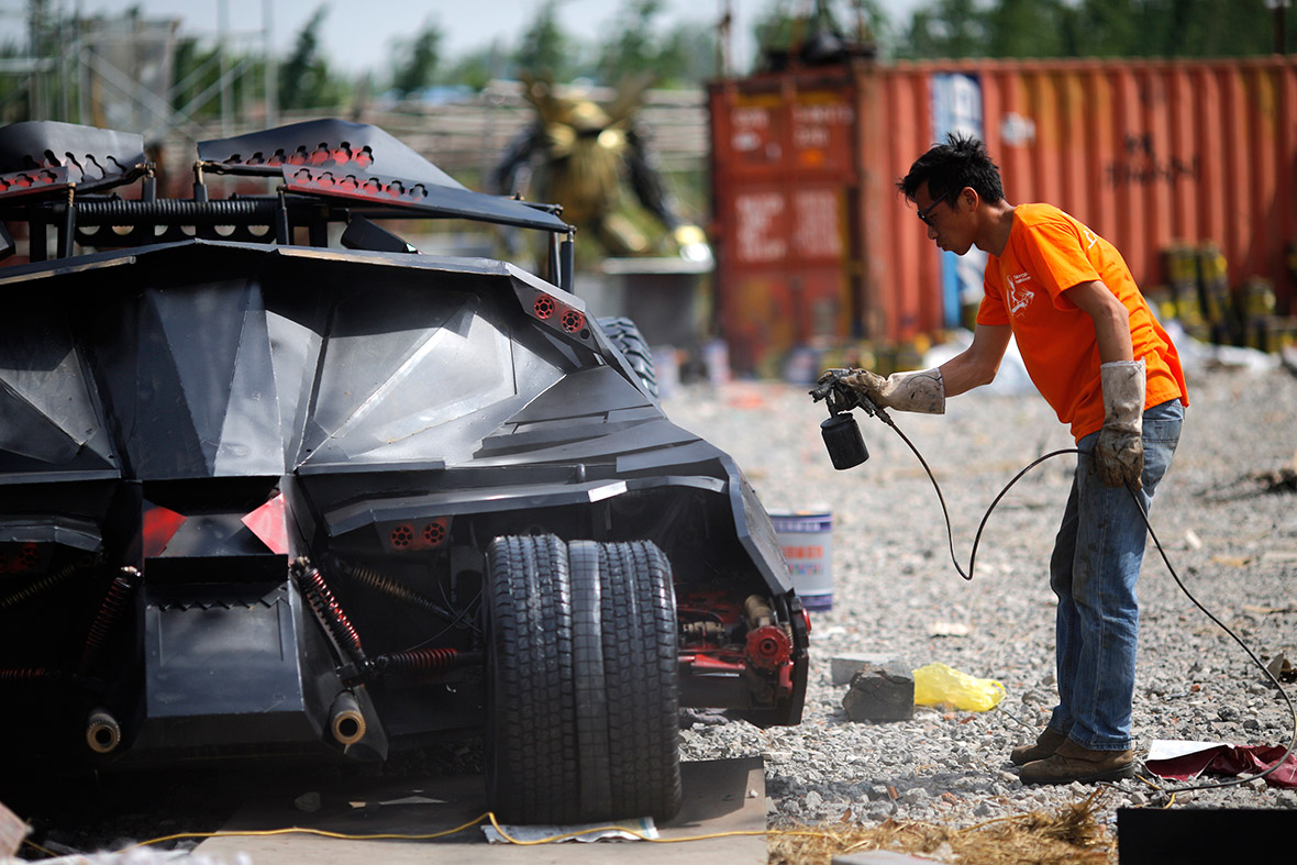 A man paints a homemade replica of the Batmobile on the outskirts of Shanghai. Li Weilei, a local businessman, builds replicas like the Batmobile, Formula One cars and Transformers for rent or sale