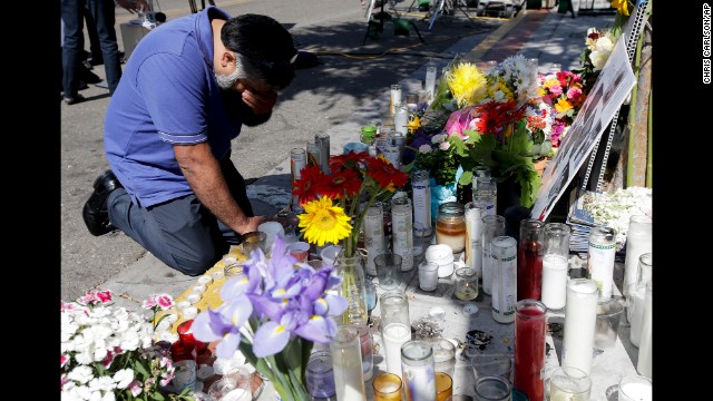 Jose Cardoso pays his respects Sunday, May 25, at a makeshift memorial at the IV Deli Mart, where part of a mass shooting took place, in Isla Vista, California. Elliot Rodger, 22, went on a rampage Friday night, May 23, near the University of California, Santa Barbara, stabbing three people to death at his apartment before shooting and killing three more in a nearby neighborhood, sheriff's officials said. Rodger also injured 13 others and died of an apparent self-inflicted gunshot wound, authorities said. 