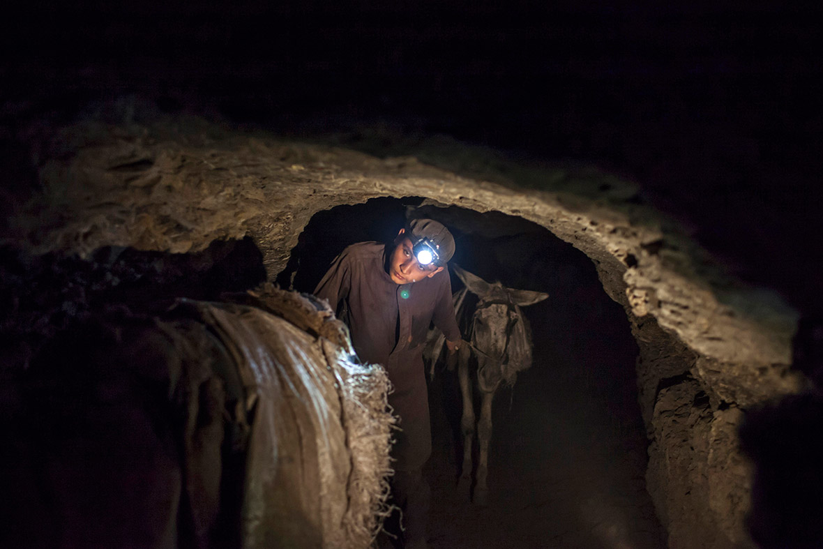 A young miner leads his team of donkeys back to the coal face underground in Choa Saidan Shah, Punjab province, Pakistan. Coal miners in Chao Saidan Shah use donkeys to transport coal from the depths of the mines to the surface. The donkeys make around 20 trips per day carrying sacks weighing about 20 kg (44 lbs) each