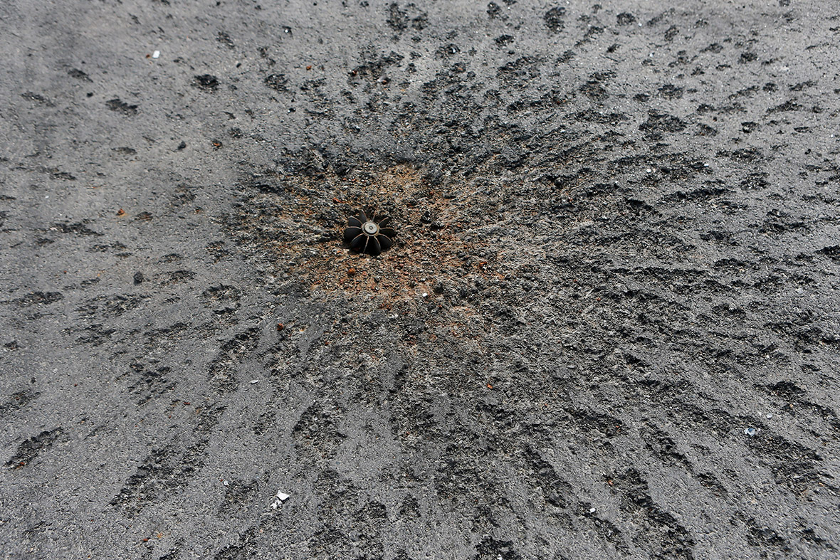 A piece of a mortar projectile is embedded in a road near the airport in Donetsk, eastern Ukraine