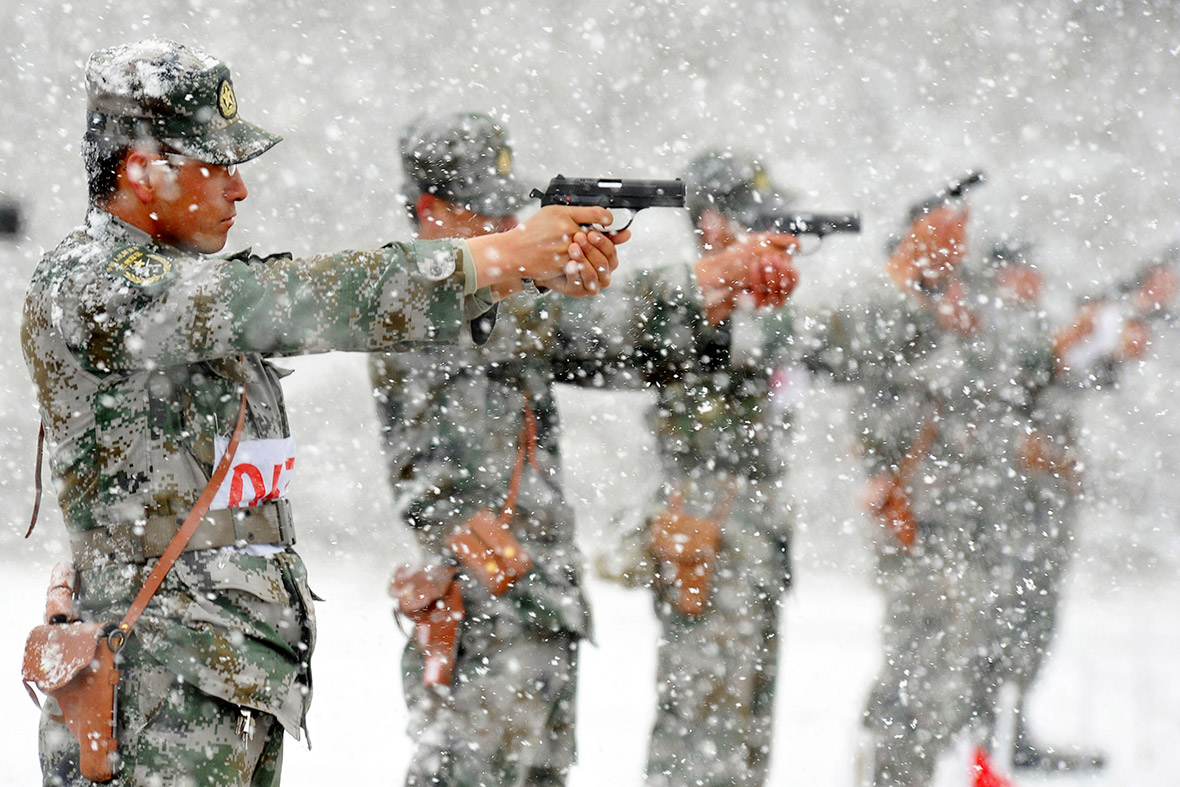 Chinese People's Liberation Army soldiers practise pistol shooting at a military base amid heavy snow in Hami, Xinjiang Uighur Autonomous Region, China