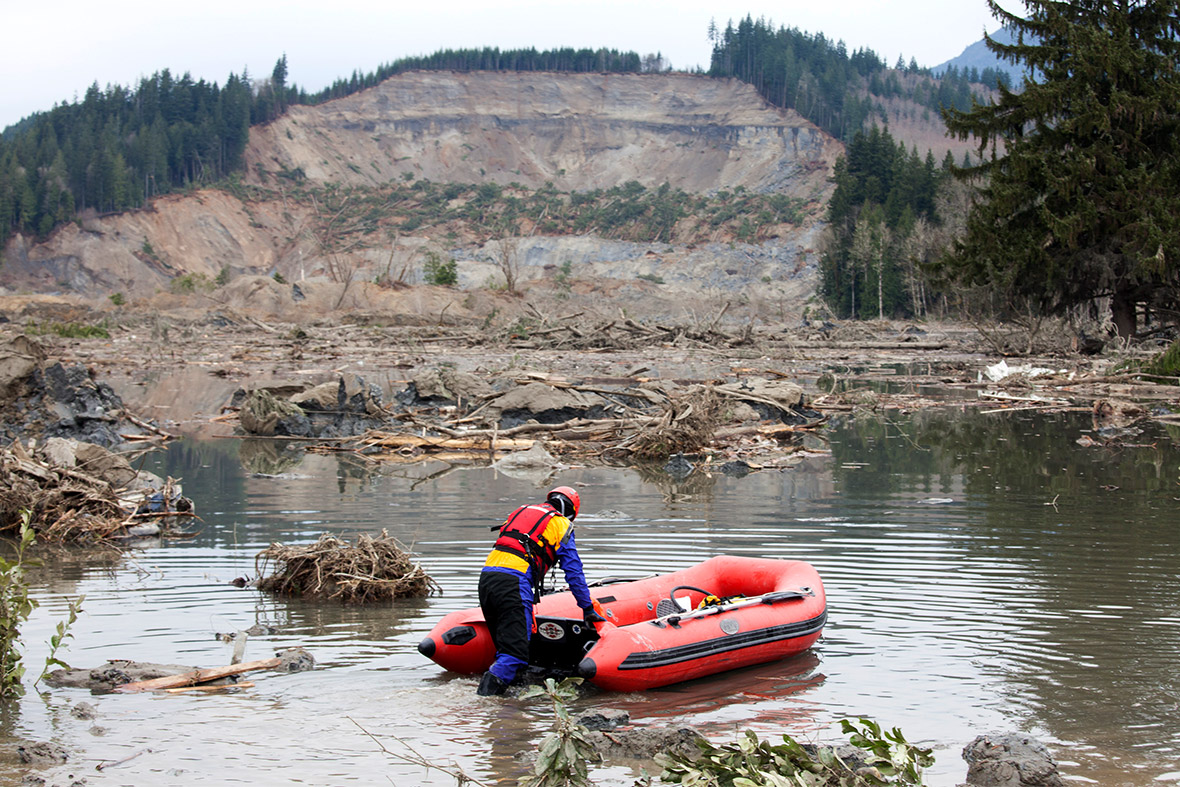 A search and rescue worker looks for survivors in the aftermath of a mudslide in Oso, Washington State