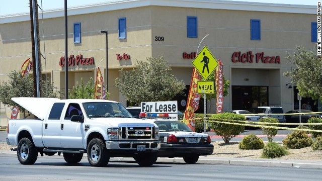 Las Vegas Metropolitan Police Department vehicles are parked outside a Las Vegas Cici's Pizza restaurant. Two police officers were shot while they were having lunch Sunday.