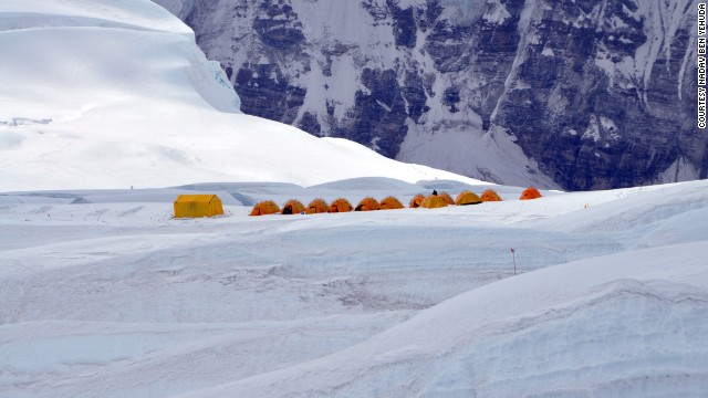 The tents from Camp 1 appear incredibly small against the backdrop of Everest.