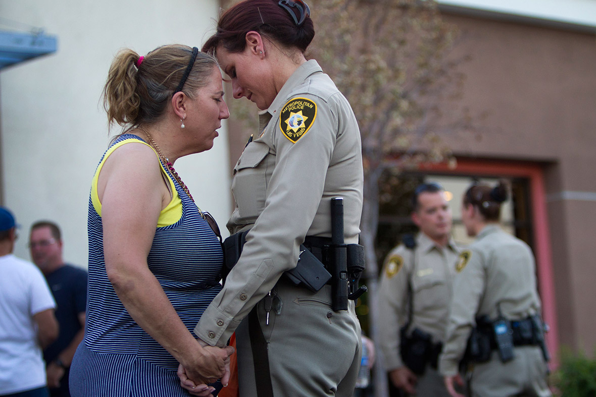 Cheri Rasmussen prays with Metro Police Lt. Roxanne McDarris in front of CiCi's Pizza during a community vigil for slain Metro Police officers in Las Vegas. Alyn Beck, 41, and Igor Soldo, 31, were ambushed and killed by Amanda and Jerad Miller while they were eating lunch in the restaurant.