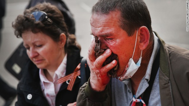 A pro-Russian activist is wounded after storming the prosecutor's office in Donetsk and clashing with riot police May 1. 