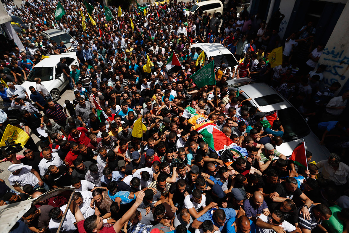 Mourners carry the body of Ahmed Sabbaren during his funeral in Jalazon refugee camp.