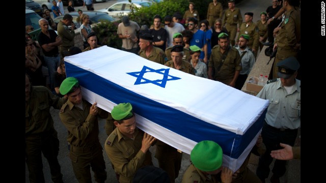 Israeli soldiers carry the coffin of 2nd Lt. Roy Peles, an infantry officer who was killed in combat, during his funeral in Tel Aviv on Sunday, July 27.