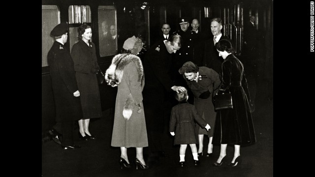 The future Queen Elizabeth II and her husband, the Duke of Edinburgh, greet their son Charles at Euston Station in London after returning from Canada in November 1951. 