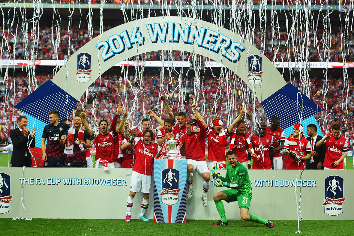 Arsenal players celebrate victory with the trophy after the FA Cup final match against Hull City at Wembley Stadium
