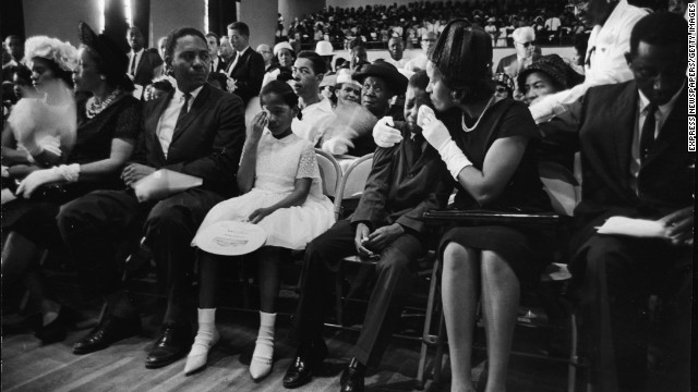 Myrlie Evers, widow of civil rights activist Medgar Evers, comforts their son Darrell while their daughter, Reena, wipes her tears during Evers' funeral on June 18, 1963. Evers was assassinated days earlier at his home in Jackson, Mississippi.