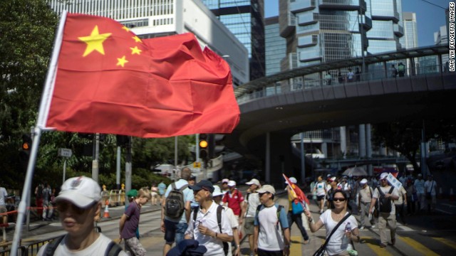 A group of pro-China protesters marches in downtown Hong Kong on August 17. Local media accused organizers of paying people to participate in the Anti-Occupy Central protest.